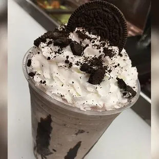 a milkshake with oreo cookies and whipped cream