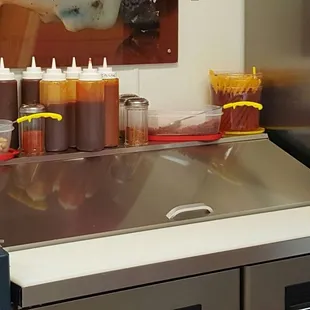 a kitchen counter with condiments and condiments