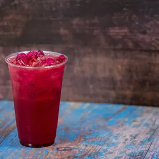 a red drink with ice cubes