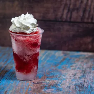 Shaved ice strawberry flavor with whipped cream.