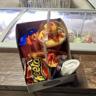 Hot cheetos with cheese, mangonada, and gansitos