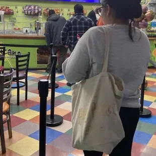 a woman standing in a fast food restaurant