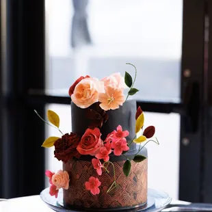 a three tiered cake decorated with flowers