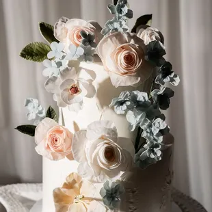 a white wedding cake with fresh flowers