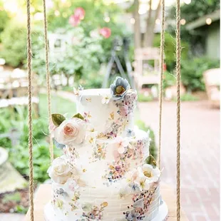 a wedding cake on a swing