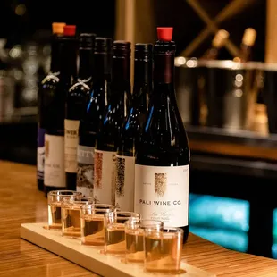 a row of wine bottles on a bar