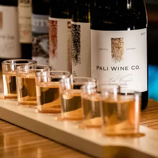 a row of glasses of wine on a bar