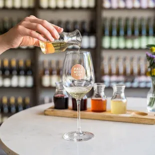 a woman pouring a glass of wine