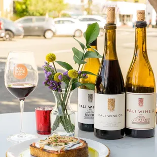 two bottles of wine and a plate of toast