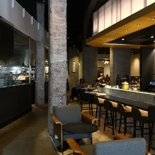 a restaurant with a bar and chairs