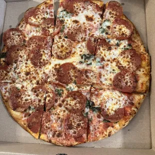 Pepperoni pizza with fresh basil