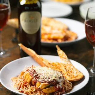 a plate of pasta and a glass of wine