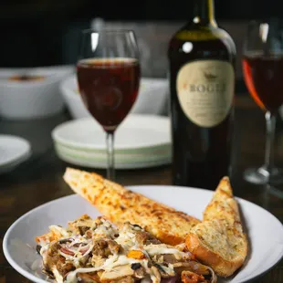 a plate of pizza and a glass of wine