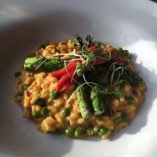 Food tasting-butternut squash risotto with peas topped with grilled asparagus