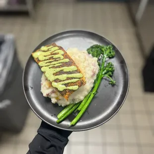 This I think is the salmon with mashed potatoes and broccolini. I don&apos;t think I tried this I was just the photo person lol