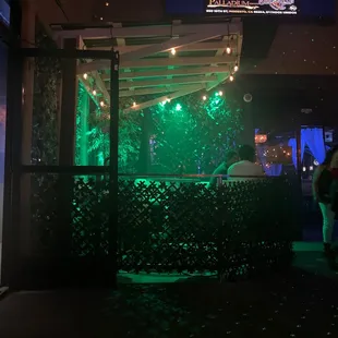 a bar with green lights