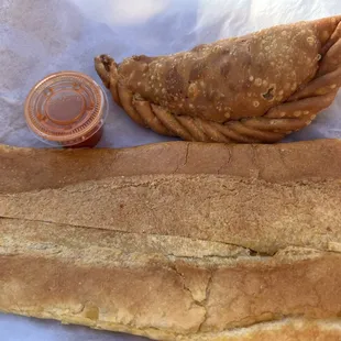 Large Cuban bread and an empanada. The latter comes with hot sauce. Cuban bread is buttery crispiness. 5 stars.