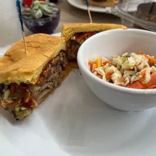 a sandwich and a bowl of coleslaw