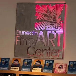 a sign for the fine art center