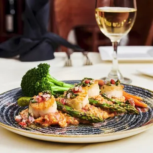 a plate of food and a glass of wine