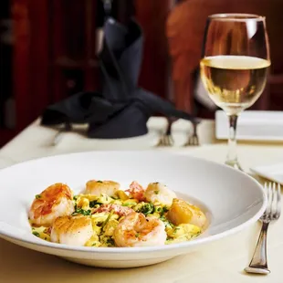 a plate of food and a glass of wine
