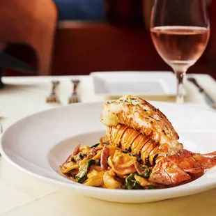 a plate of food and a glass of wine
