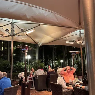 people sitting under umbrellas