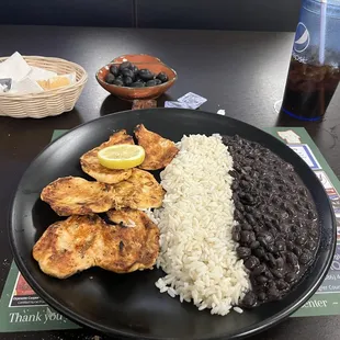 Grilled chicken breast, rice, and beans.