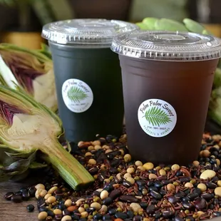 two cold drinks on a wooden tray