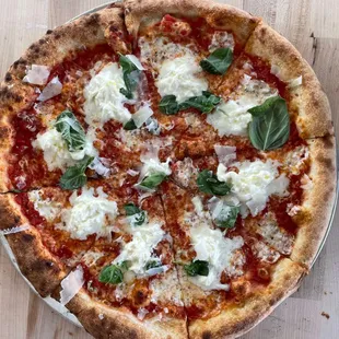 a pizza with cheese and basil