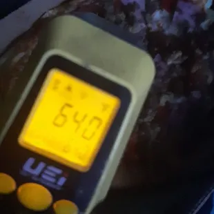 a person holding a digital thermometer
