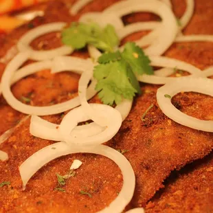 fried fish with onions and pasta