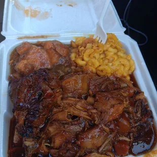 Large brown stew chicken with yams and mac