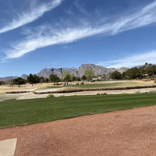On the 10th tee box, 18th green with the mountains in the background.