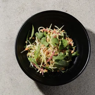 a black bowl of food on a table