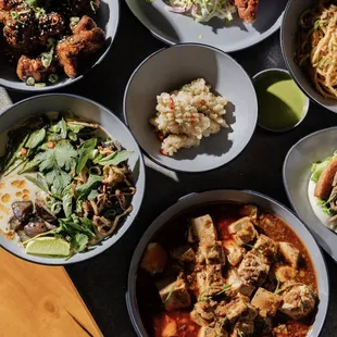 a variety of bowls of food on a table