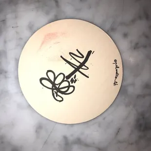 a white frisbee with black writing on it