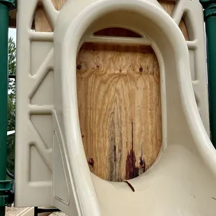 Boarded up slide with crack