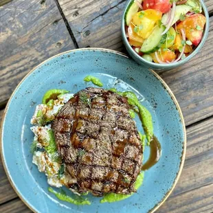 12oz grilled Black Angus Ribeye served with a greek style feta pesto, warm roasted tzatziki potatoes, and a marinated heirloom tomato,cucumb