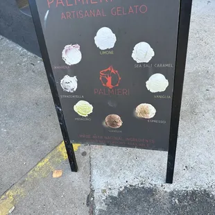 a sign on the sidewalk of a cafe