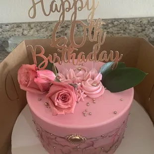 a pink birthday cake