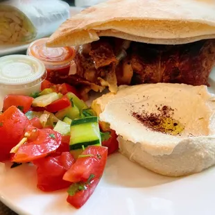 ROTISSERIE CHICKEN, 1/2; with hummus, salad, pita and sauces.