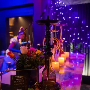 a bar with candles and flowers