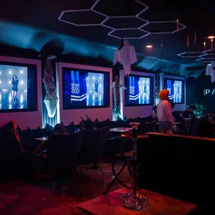 people sitting at tables in a dimly lit room