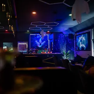 people sitting at tables in a dimly lit room