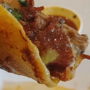 a taco being held by a fork