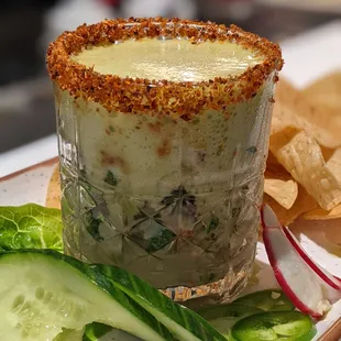 a plate of food with a drink and chips