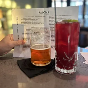 a person holding a drink and a menu