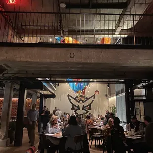 people sitting at tables in a restaurant
