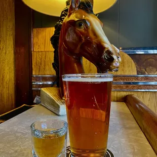 a glass of beer and a horse head